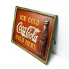 coca cola sign photograph from the side