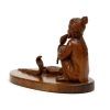 carved wood snake charmer from behind